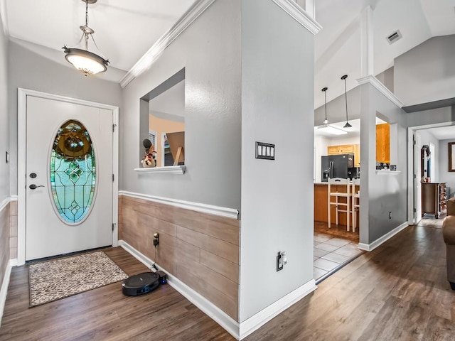 entryway with hardwood / wood-style flooring and vaulted ceiling