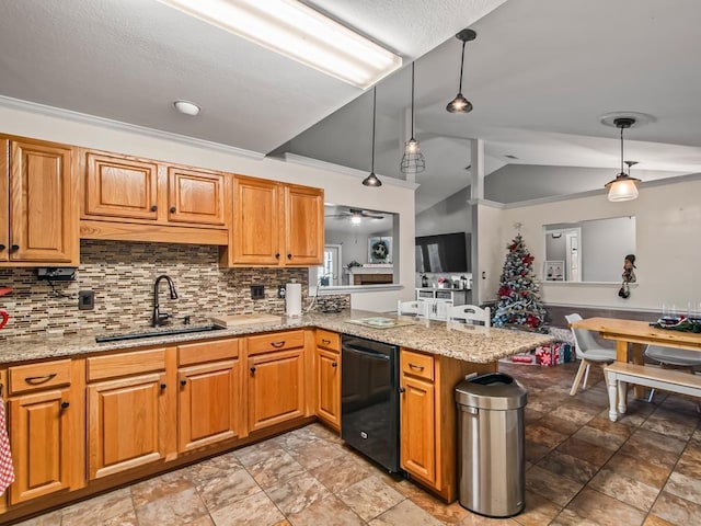 kitchen with lofted ceiling, sink, decorative light fixtures, and kitchen peninsula