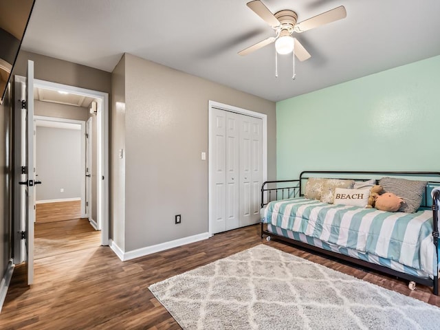 bedroom featuring dark hardwood / wood-style flooring, a closet, and ceiling fan