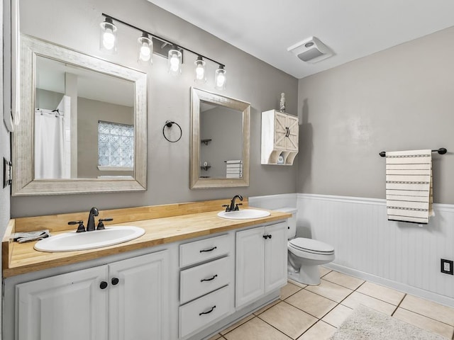 bathroom with vanity, toilet, and tile patterned flooring