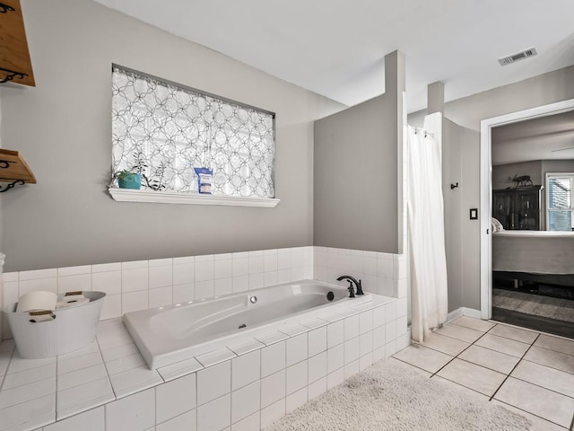 bathroom featuring tiled bath and tile patterned flooring