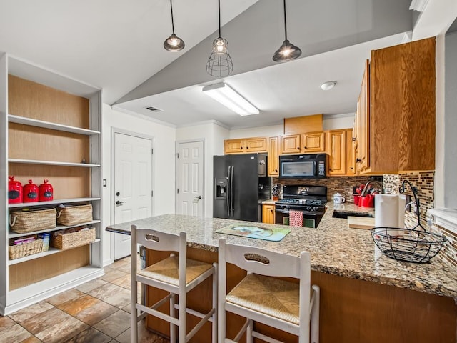 kitchen featuring decorative light fixtures, black appliances, backsplash, a kitchen breakfast bar, and kitchen peninsula