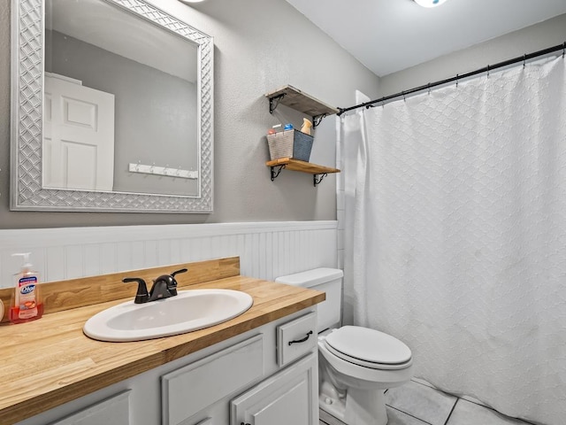 bathroom with vanity, tile patterned floors, and toilet