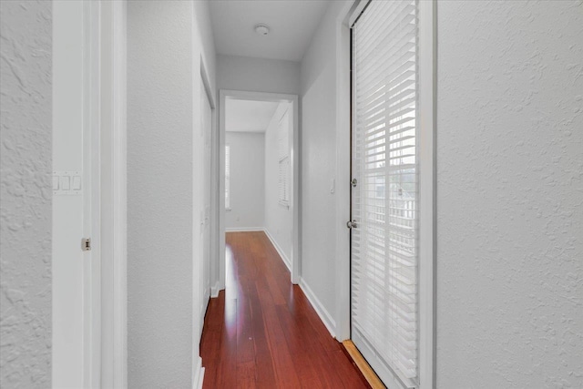 2123 Fernleigh Dr, Tallahassee, FL 32311 - corridor with a textured wall, dark wood-style flooring, and baseboards