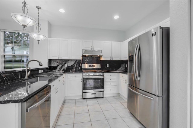 2123 Fernleigh Dr, Tallahassee, FL 32311 - kitchen with appliances with stainless steel finishes, under cabinet range hood, a sink, light tile patterned flooring, and backsplash