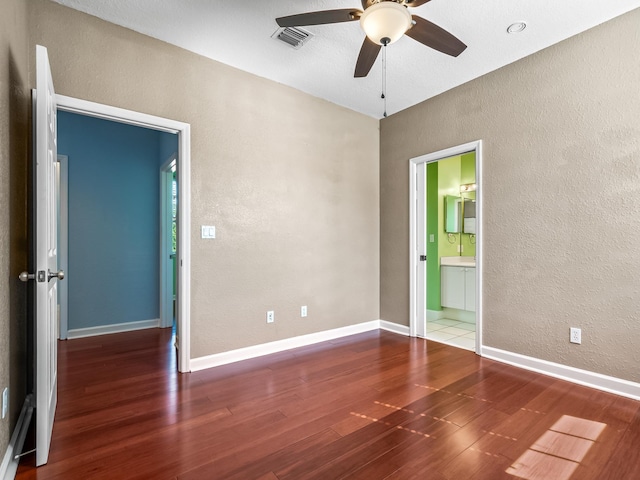 2123 Fernleigh Dr, Tallahassee, FL 32311 - empty room featuring a textured wall, wood finished floors, ceiling fan, and baseboards