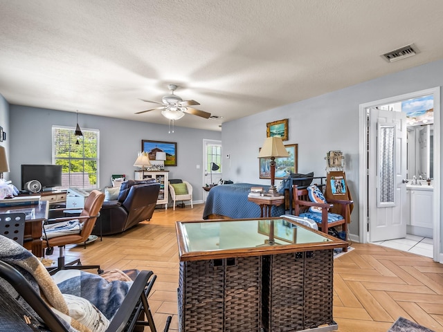 2123 Fernleigh Dr, Tallahassee, FL 32311 - living area with ceiling fan, baseboards, a textured ceiling, and a desk