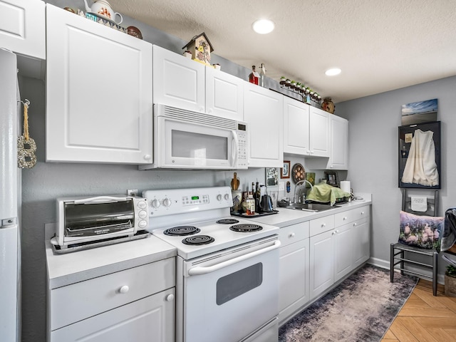 2123 Fernleigh Dr, Tallahassee, FL 32311 - kitchen featuring white appliances, light countertops, a textured ceiling, recessed lighting, and white cabinets