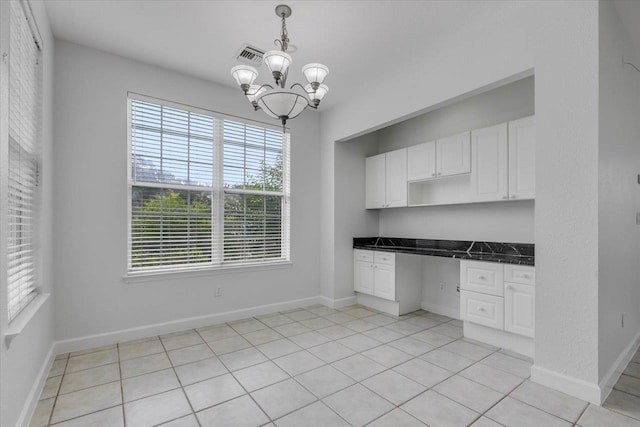 2123 Fernleigh Dr, Tallahassee, FL 32311 - kitchen featuring dark countertops, white cabinetry, a chandelier, and decorative light fixtures