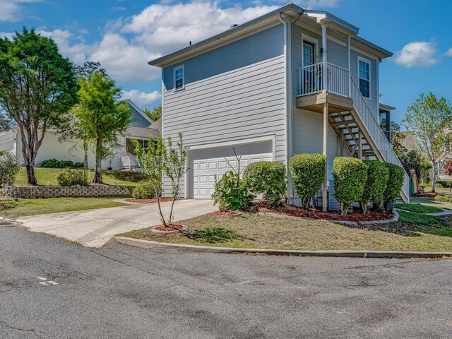 2123 Fernleigh Dr, Tallahassee, FL 32311 - view of property exterior featuring stairs, an attached garage, and concrete driveway