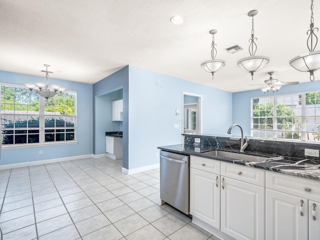 2123 Fernleigh Dr, Tallahassee, FL 32311 - kitchen with stainless steel dishwasher, a sink, white cabinets, a chandelier, and hanging light fixtures