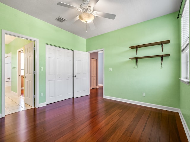2123 Fernleigh Dr, Tallahassee, FL 32311 - unfurnished bedroom featuring baseboards, wood finished floors, a closet, and a ceiling fan