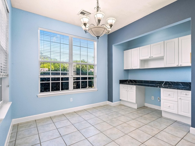 2123 Fernleigh Dr, Tallahassee, FL 32311 - kitchen with white cabinets, a chandelier, light tile patterned floors, pendant lighting, and open shelves