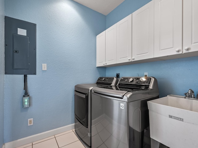 2123 Fernleigh Dr, Tallahassee, FL 32311 - clothes washing area featuring cabinet space, washer and clothes dryer, electric panel, light tile patterned floors, and baseboards