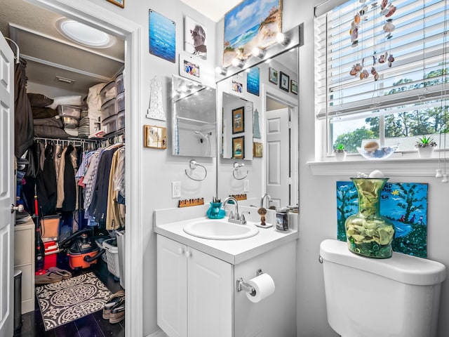 2123 Fernleigh Dr, Tallahassee, FL 32311 - bathroom with toilet, vanity, and a walk in closet