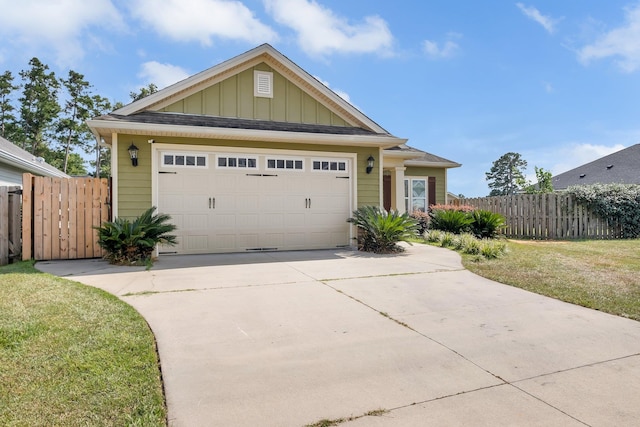 view of front of home featuring a front lawn and a garage