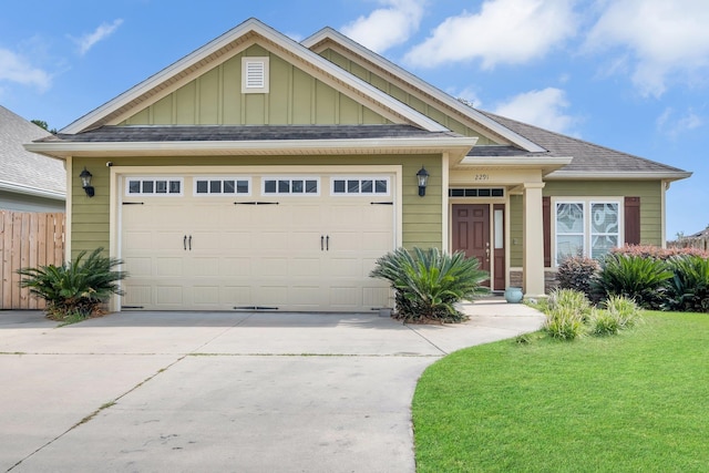 craftsman-style home featuring a front lawn and a garage