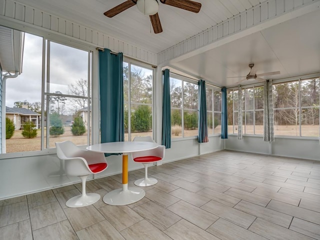 unfurnished sunroom with ceiling fan