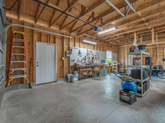 garage with a garage door opener and a workshop area