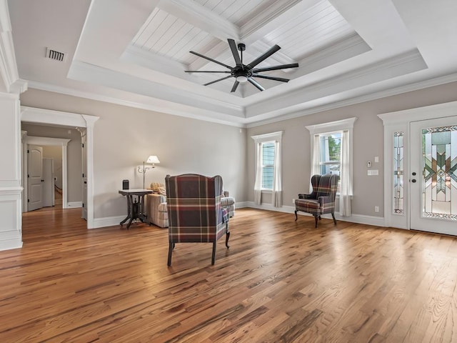 sitting room featuring hardwood / wood-style floors, crown molding, a raised ceiling, and ceiling fan