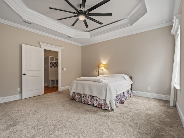 carpeted bedroom featuring crown molding, ceiling fan, and a tray ceiling