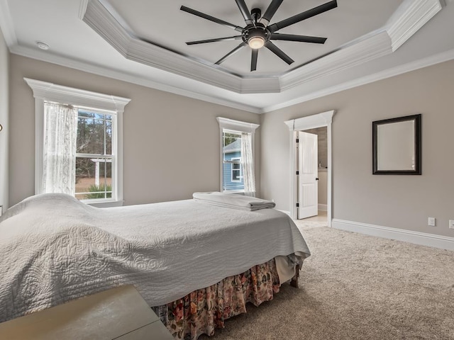 carpeted bedroom featuring ornamental molding, a raised ceiling, and ceiling fan