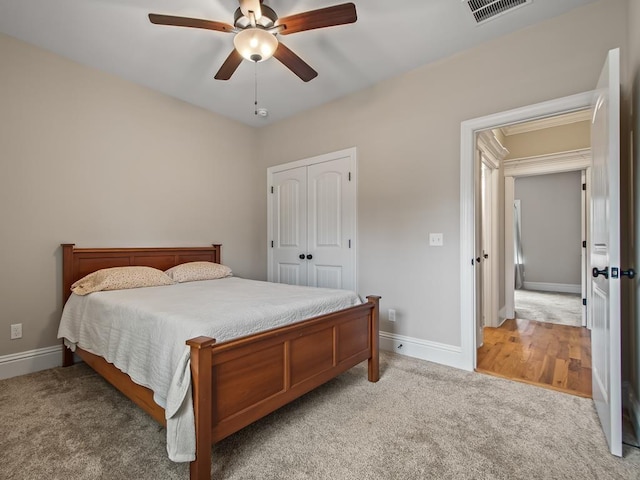 carpeted bedroom with a closet and ceiling fan