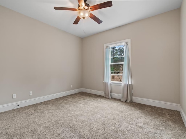 carpeted spare room with ceiling fan