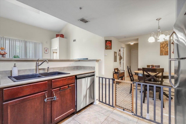kitchen with light tile patterned floors, a sink, visible vents, reddish brown cabinets, and dishwasher