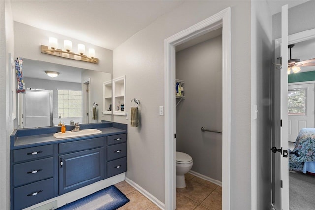 bathroom with tile patterned floors, ceiling fan, vanity, and toilet