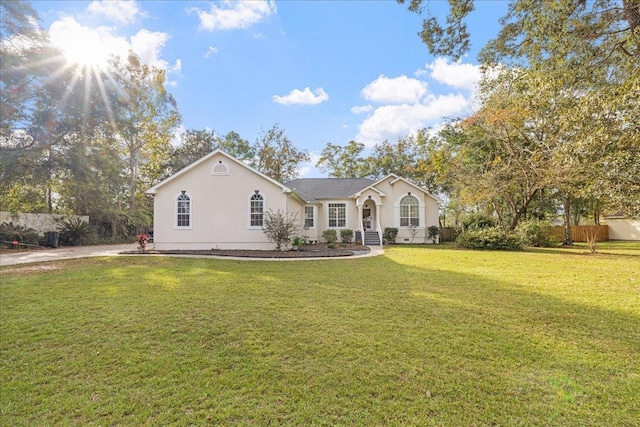 ranch-style home with a front lawn