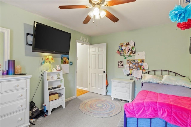 bedroom with ceiling fan and light carpet