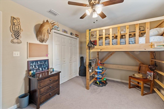 bedroom with ceiling fan, a closet, and light colored carpet