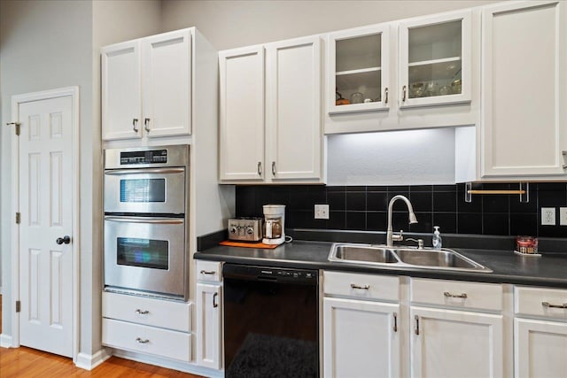 kitchen featuring sink, white cabinets, and black dishwasher