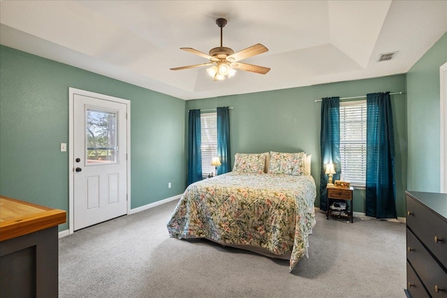 bedroom with access to exterior, carpet floors, a raised ceiling, and ceiling fan