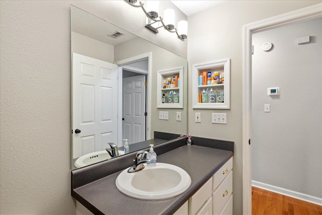 bathroom featuring hardwood / wood-style flooring and vanity