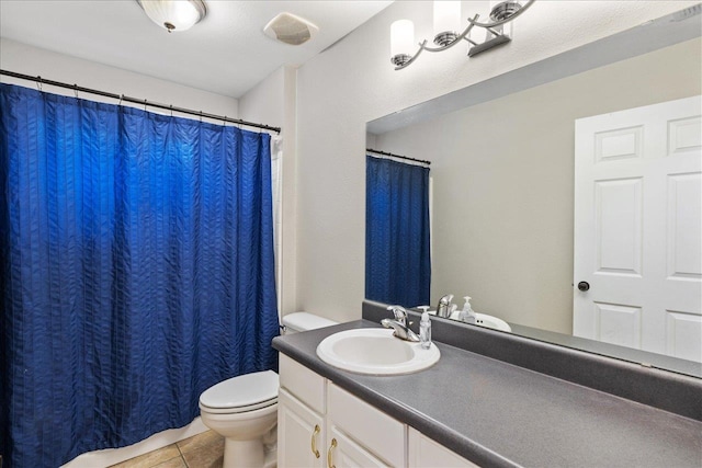 bathroom with tile patterned floors, vanity, and toilet