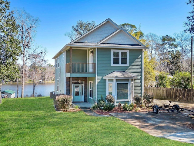 view of front of property featuring a water view, a balcony, central AC unit, and a front lawn