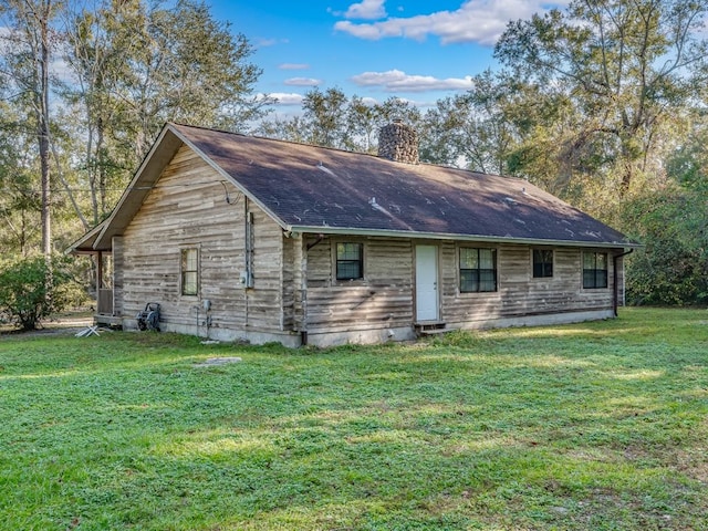 view of property exterior with a yard