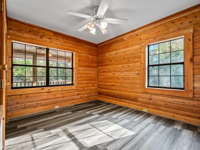 spare room with hardwood / wood-style floors, a textured ceiling, and ceiling fan