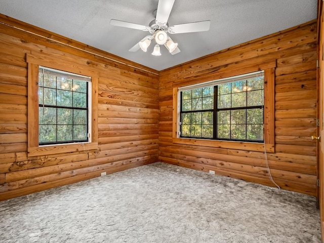 carpeted empty room with a textured ceiling and ceiling fan