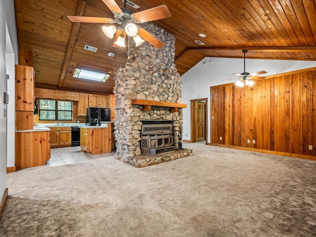 unfurnished living room featuring lofted ceiling with beams, wood ceiling, light carpet, and ceiling fan