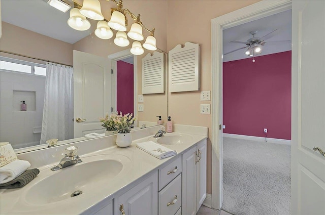 full bathroom featuring a sink, a shower with curtain, ceiling fan with notable chandelier, and double vanity