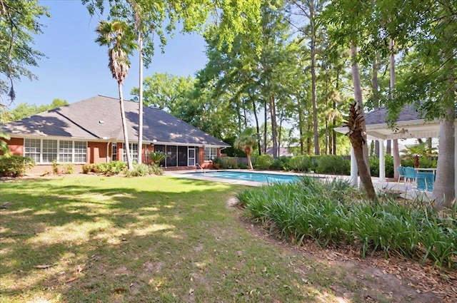 view of yard with a fenced in pool