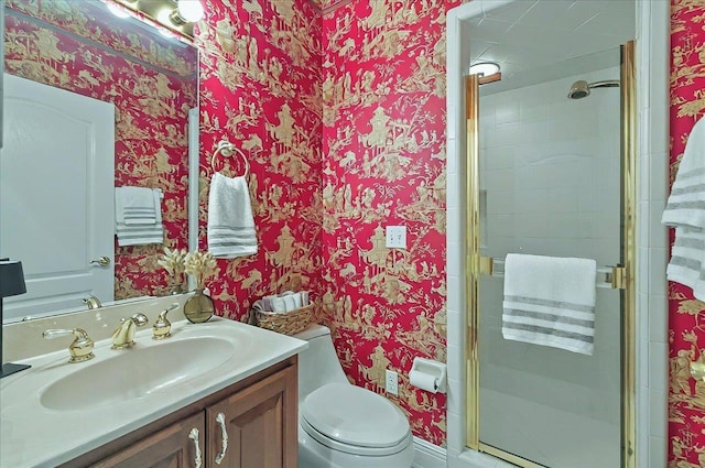 full bathroom with vanity, a stall shower, wallpapered walls, and toilet