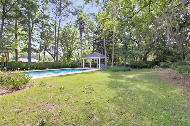 view of yard featuring a fenced in pool and a gazebo