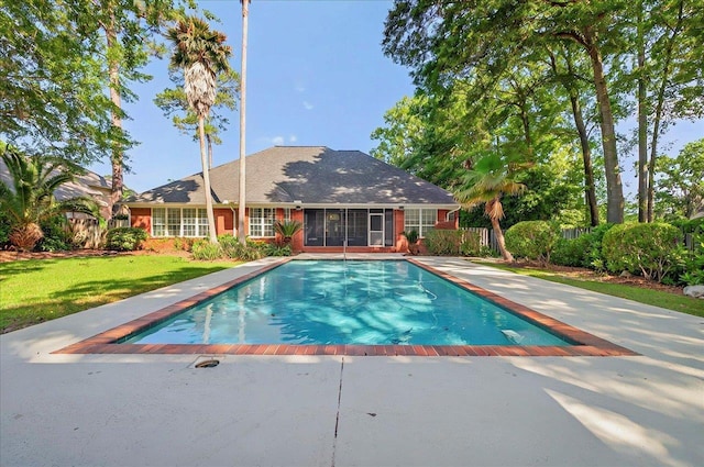 view of swimming pool featuring a fenced in pool, a patio, and a yard