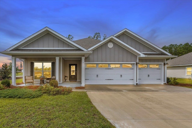 craftsman-style house with covered porch, an attached garage, driveway, and board and batten siding