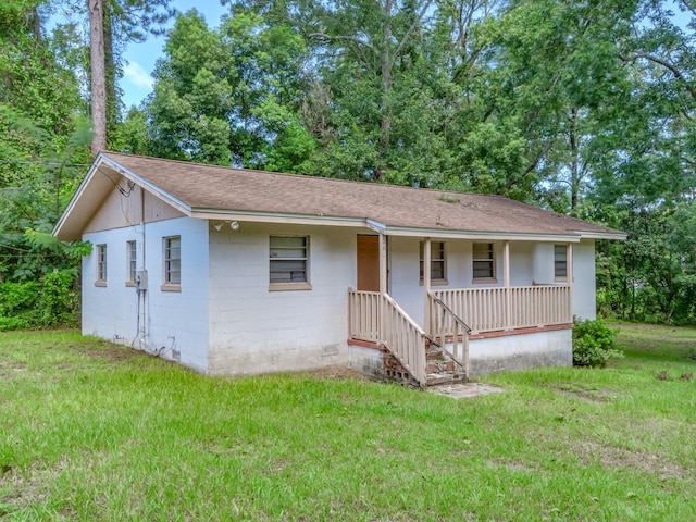 ranch-style home with a front yard and a porch