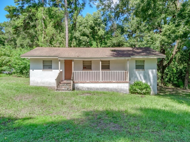 ranch-style home with a front yard and a porch